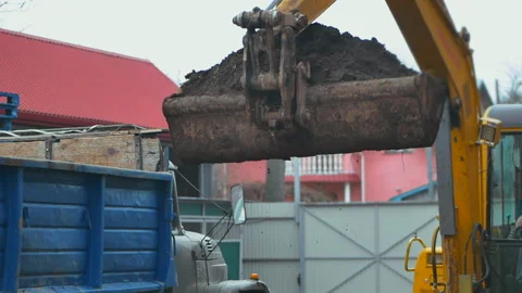 Old digger digs the ground. Excavator loading earth in slow motion Stock Footage 231221587
