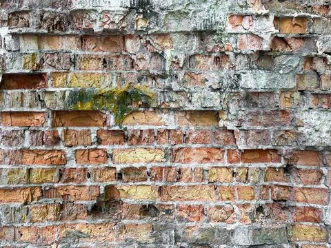 An old dilapidated brick wall of red brick Stock Photos