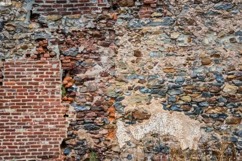 Old dilapidated stone wall with partial brickwork 写真素材