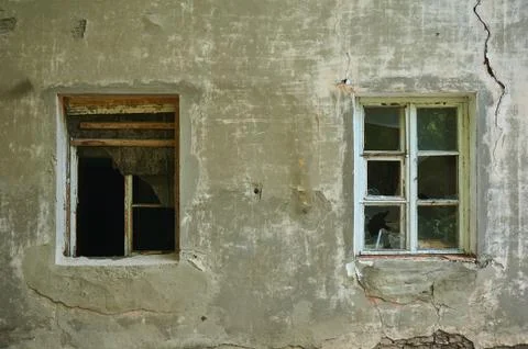 The old dirty broken window on the old dirty wall with cracks. Stock Photos