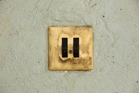 Old dirty double switch on old wall in workshop Stock-Fotos