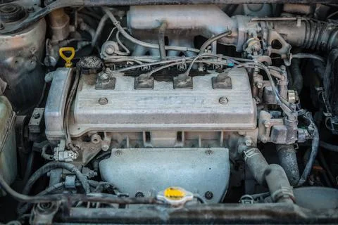 Old dirty engine under the hood of a car Stock Photos