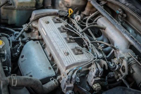 Old dirty engine under the hood of a car Stock Photos
