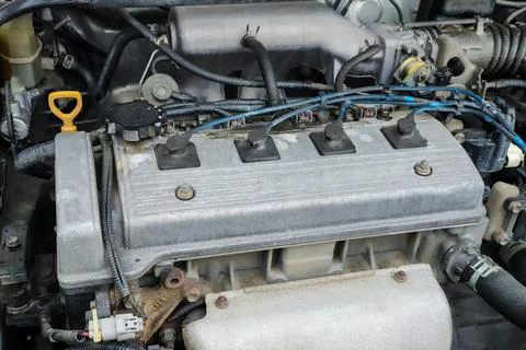 Old dirty engine under the hood of a car close-up Stock Photos