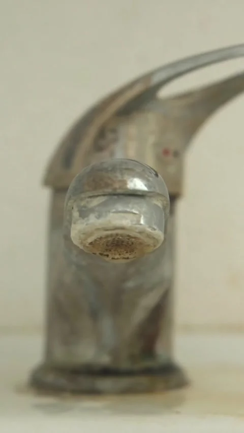 An old, dirty, hard water scaled, dripping or leaking faucet Stock Footage 320634685