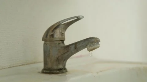 An old, dirty, hard water scaled, dripping or leaking faucet Stock Footage 320634822