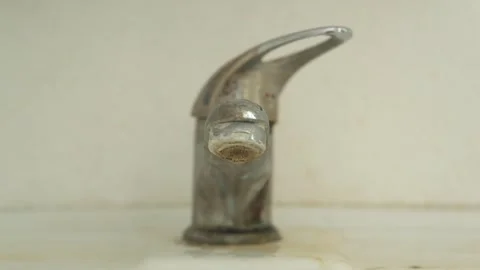 An old, dirty, hard water scaled, dripping or leaking faucet Stock Footage 320797019