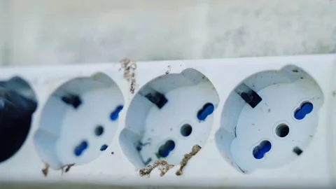 Old dirty outlet extension socket on external wall with high voltage and two Stock Footage 259898851