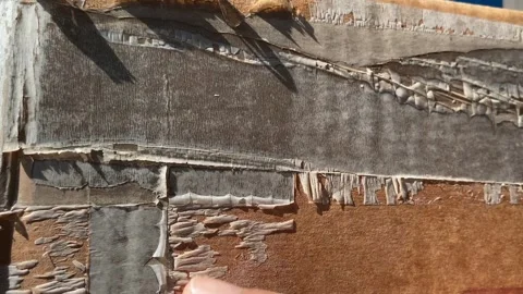 Old dirty plastic tape wrap on brown cardboard box sunny day close up view. Video stock 251509680