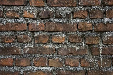 Old dirty red brick wall with light cement. rough surface texture. stains of  Stock Photos