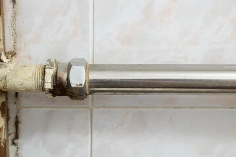 Old dirty rusty pipe in a bathroom in a residential apartment without repair, Stock Photos