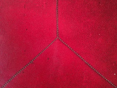 Old dirty surface made of artificial leather in red. Flat lay. Copy space. Stock Photos