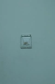 Old Dirty White Light Switch Mounted on Light Blue Wall Stock Photos