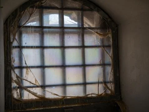 Old dirty window with cracked translucent film Stock Photos