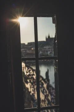 Old dirty window with spider web on Old Town Bridge Tower with blurred Charle Stock Photos