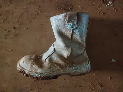 Old Dirty Work Boot on Dusty Ground Stock Photos