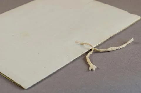 An old document folder with ties. Paper folder on gray background. Close-up.  Stock Photos