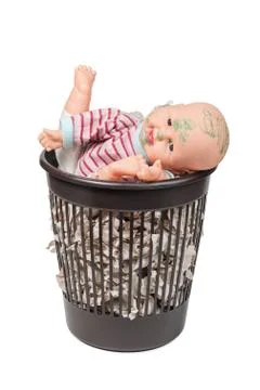 Old doll in the trash can Foto stock