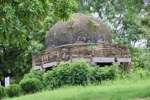Old domed masonry structure surrounded by greenery Stock Photos