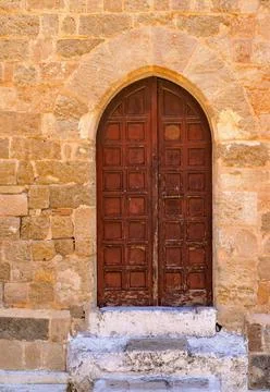 Old door on an ancient wall Stock Photos