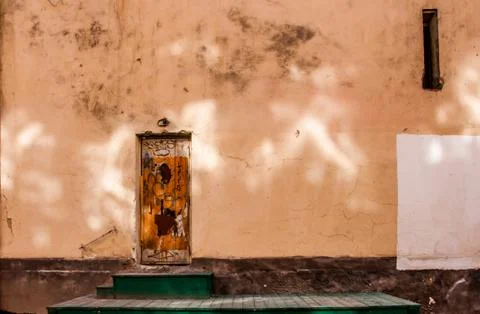 Old door on the empty wall Stock Photos