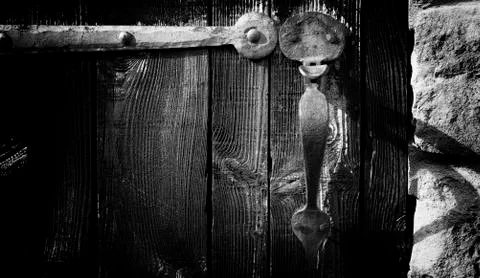 Old door handle old fashioned rusty forged hinge forged near th century Stock Photos