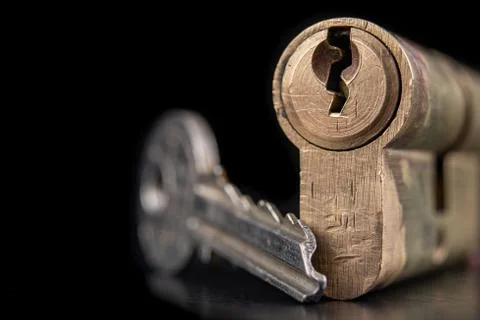 A old door lock on a dark background. A patent and keys to secure the front d Stock Photos