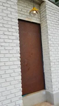 Old door in rustic white brick wall Stock Photos