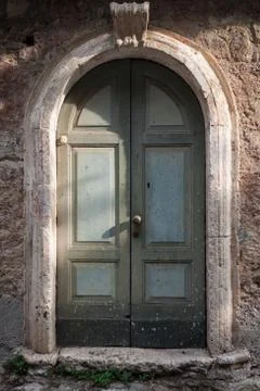 Old door in a stone wall Stock Photos