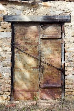 An old double-leaf door of a stone barn Stock Photos
