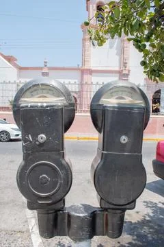 Old double parking meters in Cocula Jalisco with colonial church in background 写真素材