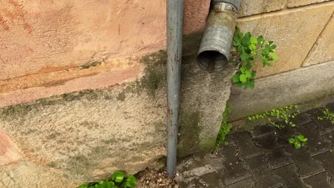 An old drainpipe leaks and drips during rain Stock Footage 312289351