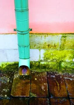 Old drainpipe on the wall. Stock Photos