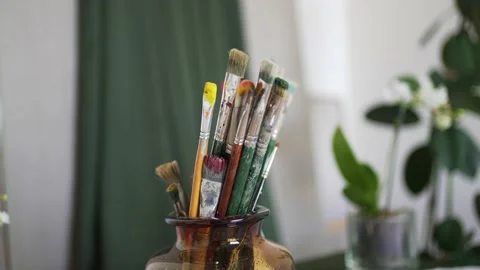 Old drawing brushes are stored in a stand. Artist's Studio Stock Footage 157265479