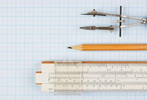 Old drawing tools on graph paper Fotos de archivo