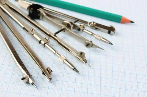 Old drawing tools on graph paper Fotos de archivo