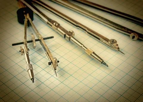 Old drawing tools on graph paper Fotos de archivo