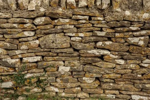 Old dry stone wall texture with natural rocks, lichen, and ancient pattern,.. Stock Photos