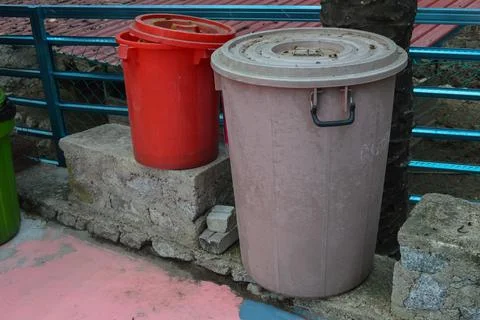 Old dustbin on the park at the roadside Stock Photos