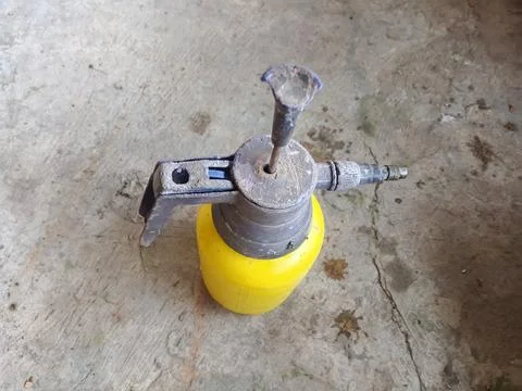 Old Dusty Garden Pressure Sprayer Bottle on Concrete Floor Stock Photos