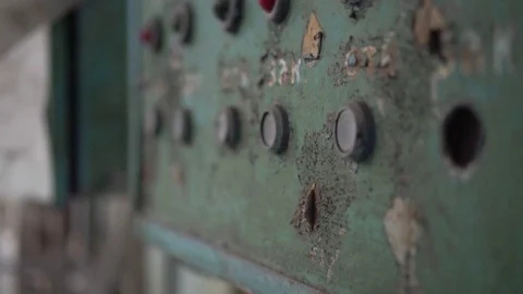 Old dusty green electrical panel with lots of red lights and buttons in a flower Stock Footage 125613744