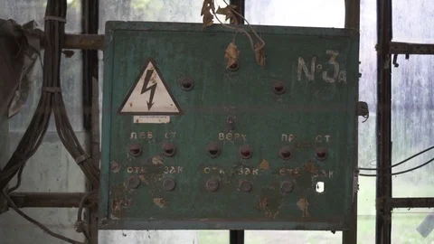 Old dusty green electrical panel with lots of red lights and buttons in a flower Stock Footage 125613899