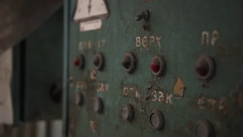 	Old dusty green electrical panel with lots of red lights and buttons in a flowe Stock Footage 125613962