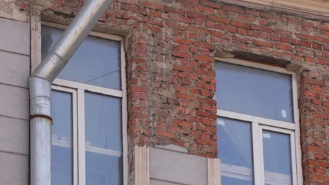 Old dusty house facade with brick wall and couple of windows in daylight. Stock Footage 107111271