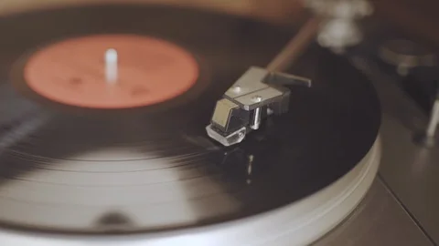 An old dusty record player from the 1970's is playing a black vinyl record Stock Footage 94978951