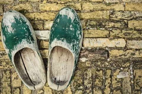 Old dutch clogs on a brick background Stock Photos