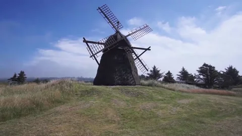 Old Dutch windmill in a meadow during summer. Sunset and lens flare. Stock Footage 140393157