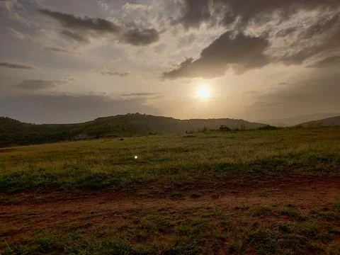 An old earthen road path running beyond the hills Stock Photos