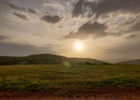 An old earthen road path running beyond the hills Stock Photos