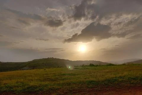 An old earthen road path running beyond the hills Stock Photos